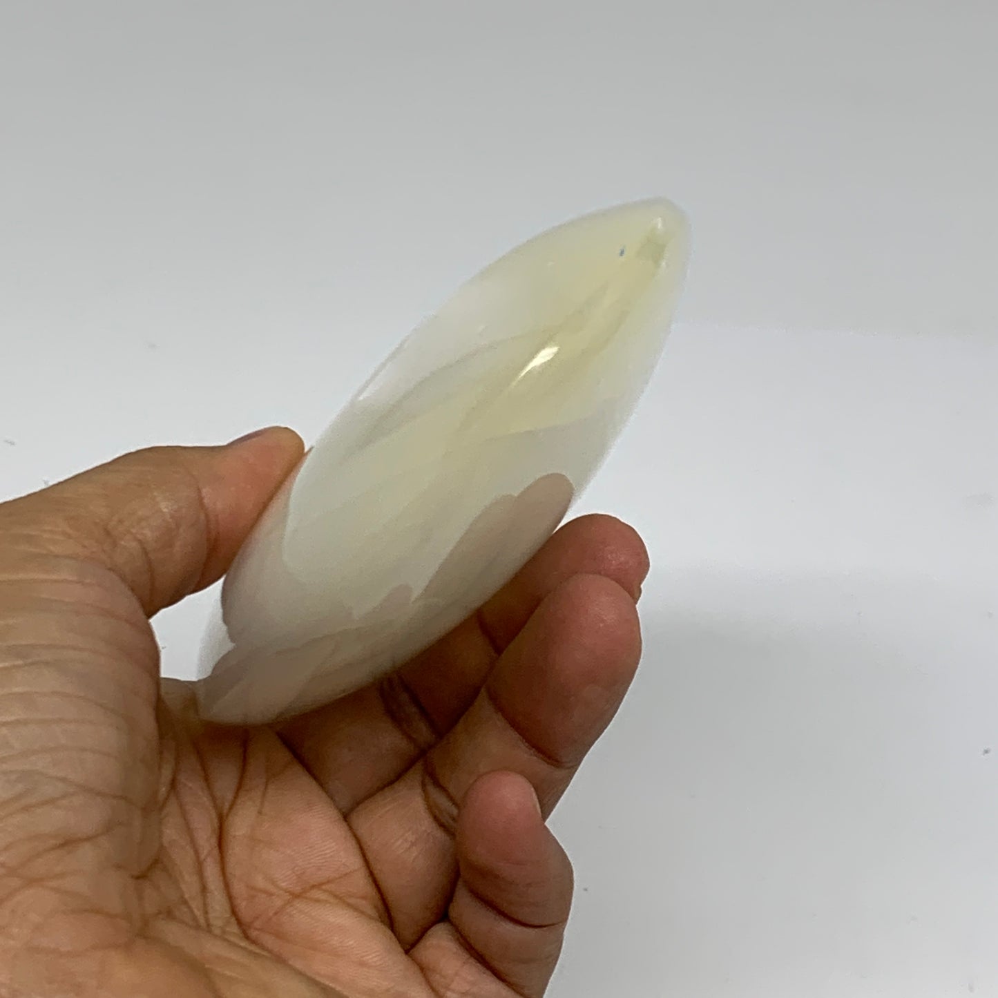 0.95 lbs, 5.2"x3.5"x1.3", White Selenite Palmstone Crystal Pillow Reiki, B35917