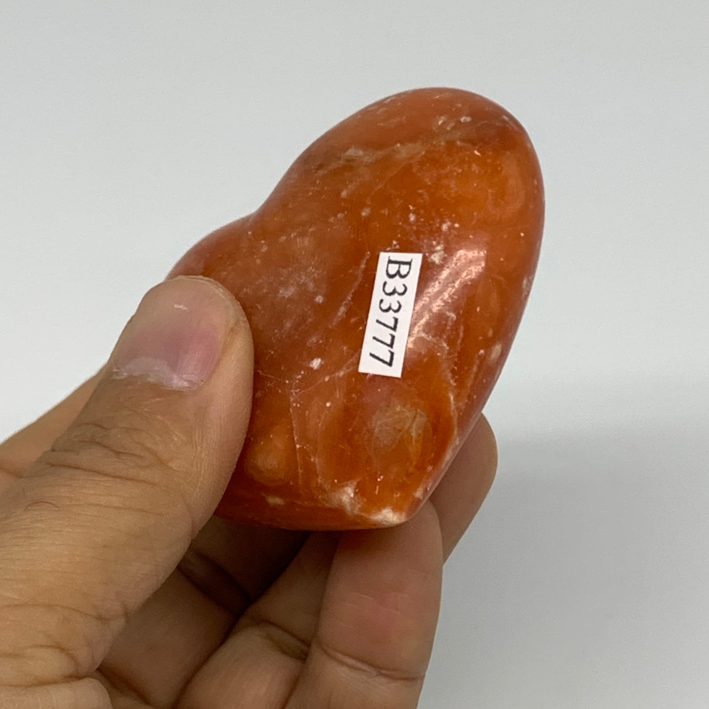 117.8g, 2.2"x2.5"x1.1" Orange Calcite Heart Gemstones from Madagascar, B33777