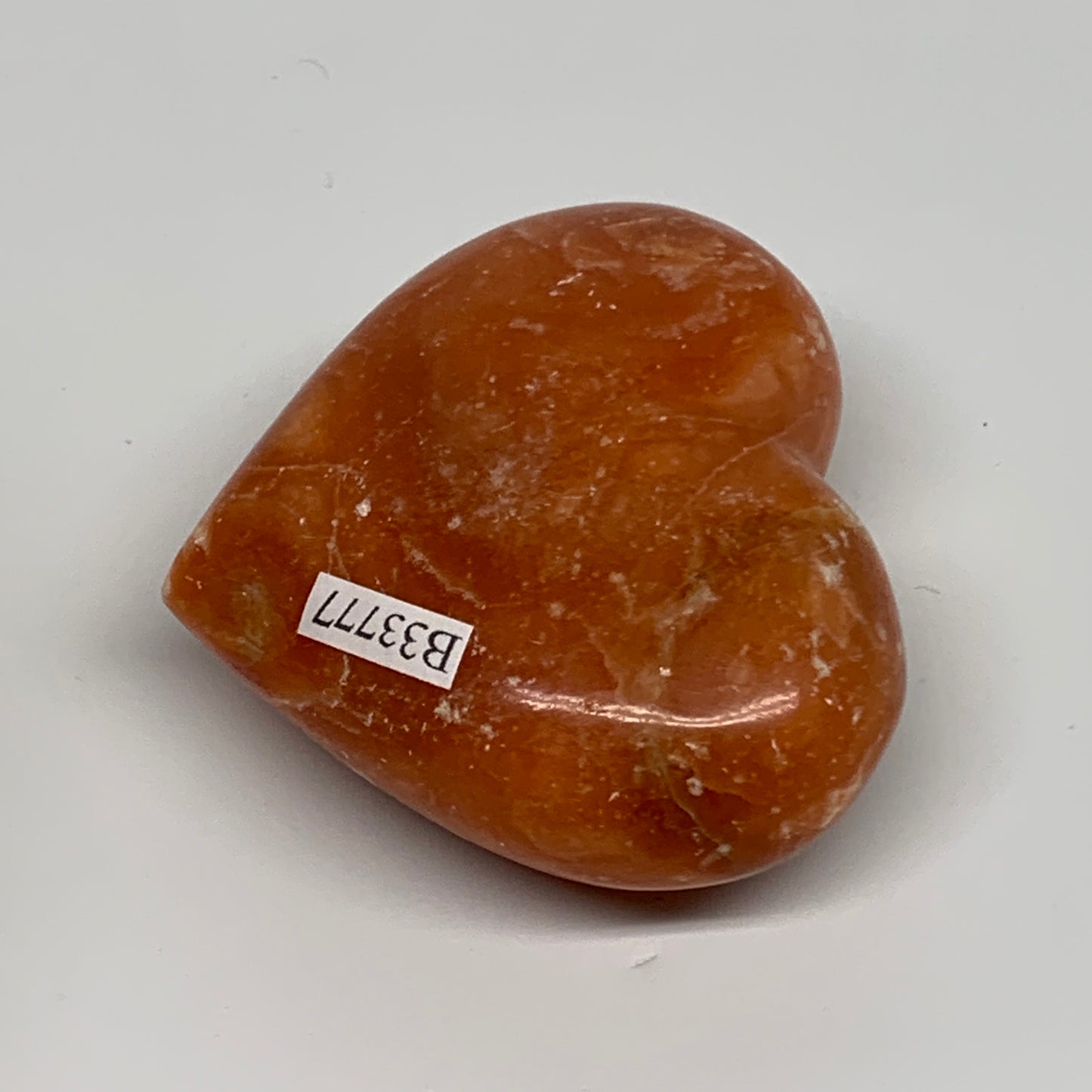 117.8g, 2.2"x2.5"x1.1" Orange Calcite Heart Gemstones from Madagascar, B33777